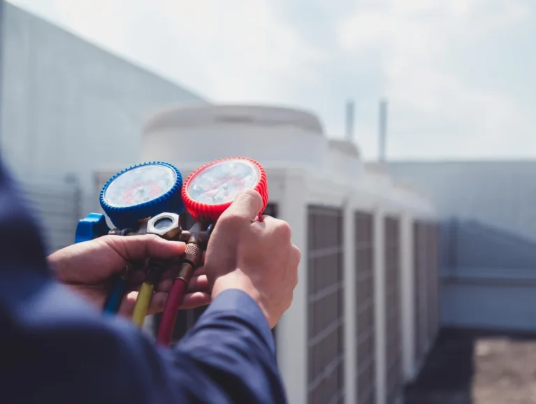 hvac-technician-inspecting-commercial-air-conditioner